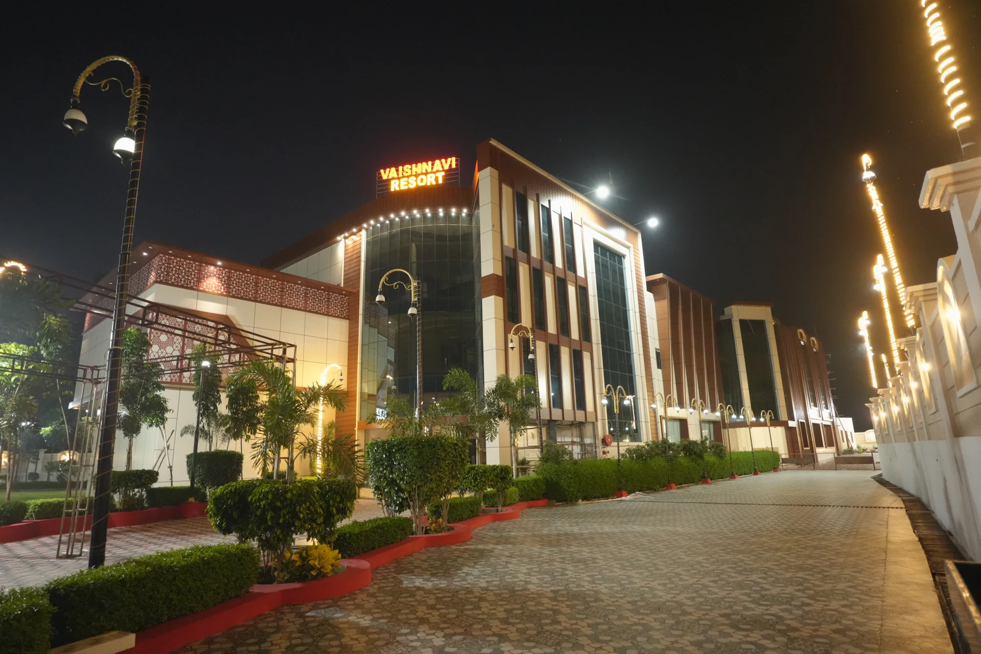 Vaishnavi Resort illuminated at night